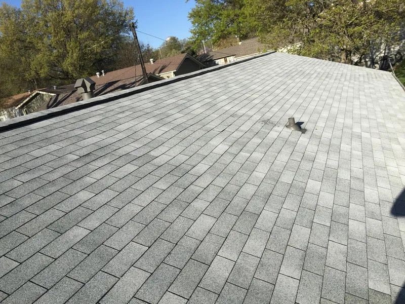 A residential roof that has received professional services for roof replacement in Kansas City.
